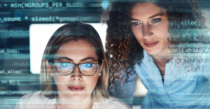 two-women-facing-laptop-with-code-cloud-guard