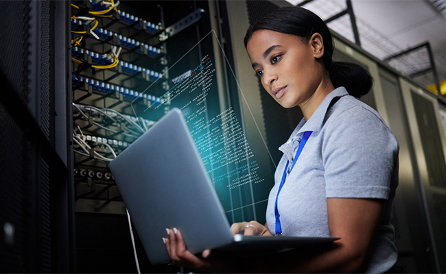 Multi-ethnic IT engineers setting up computer cluster